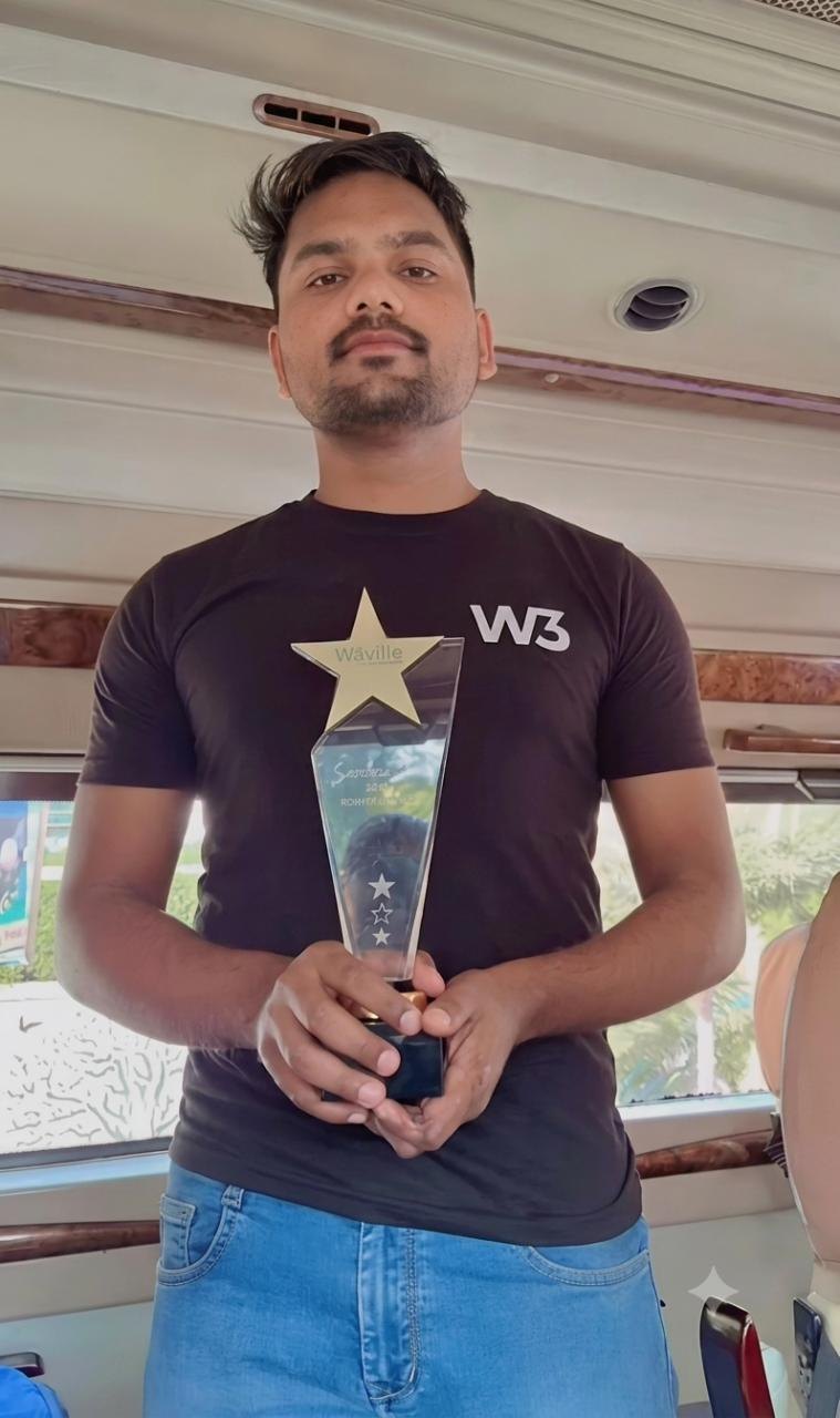 Rohit holding the Rising Star trophy at W3villa Technologies